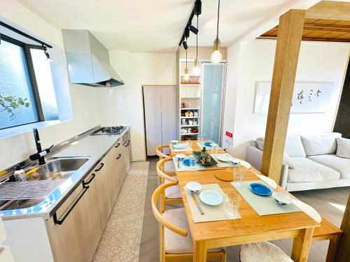 a kitchen and living room with a wooden table in a room at Zen House - Tajimi in Tajimi