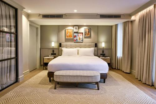 a bedroom with a large bed and a large window at Radisson Blu Hotel, London Bond Street in London