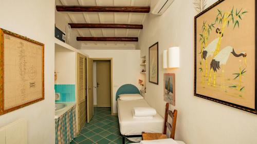 a corridor of a room with a bathroom at Futura anima sarda, villa sul tramonto con piscina privata in Costa Paradiso