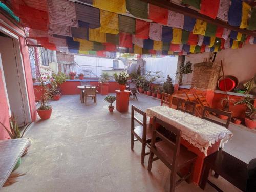 a room with tables and potted plants and flags at Hotel Pokhara Peace in Kathmandu
