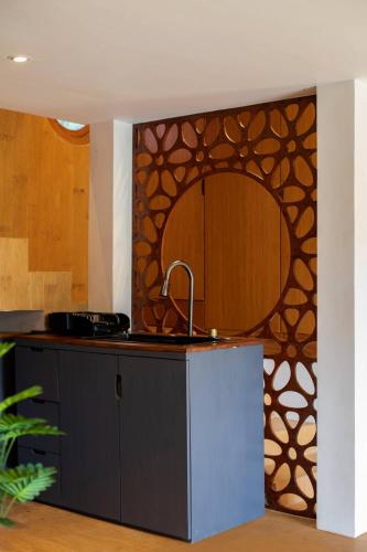 a kitchen with a sink and a mirror on the wall at Cheria Eco Lodge in Selong Belanak