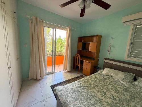 a bedroom with a bed and a dresser and a window at Villa Clementinka - 200 meters from the sea in Chlorakas