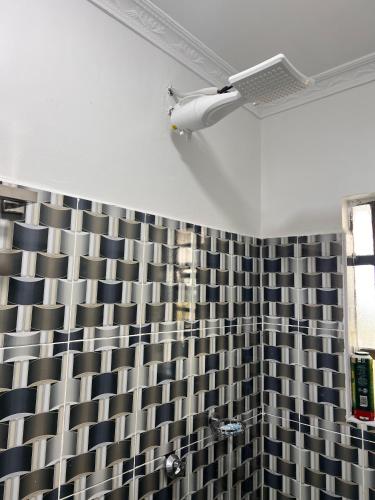 a bathroom with a black and white shower curtain at Studio in Nanyuki with Mount Kenya Views in Nanyuki