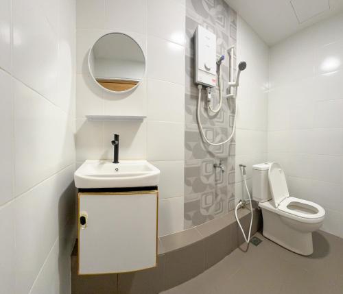 a bathroom with a sink and a toilet at The Glam Inn in Kampong Limputang