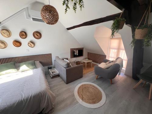 a bedroom with a bed and a living room at Centre Nemours - Climatisation - Cosy Deluxe in Nemours