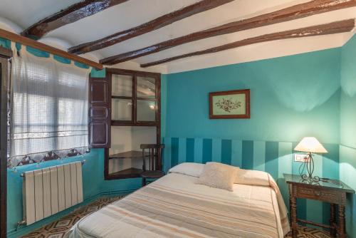 Ένα ή περισσότερα κρεβάτια σε δωμάτιο στο Casa Rural Abuelo Luis