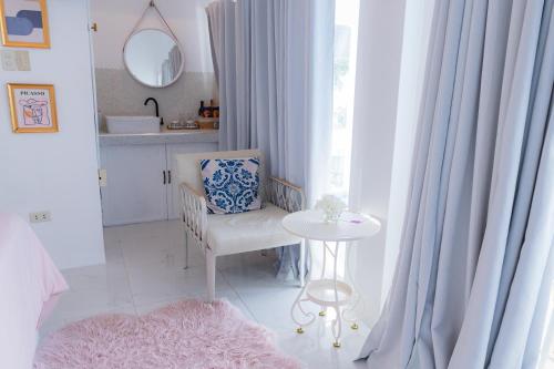 a room with a table and a chair and a window at Bintana Sa Paraiso in Mambajao