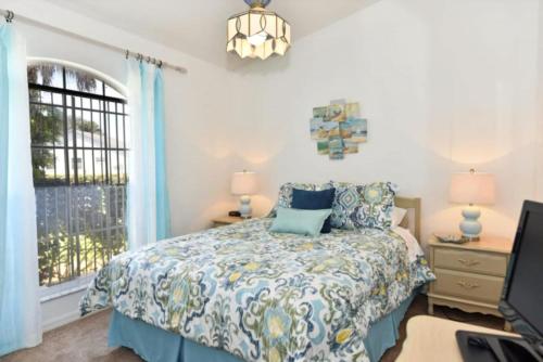 a bedroom with a bed and a window at Rise & Shine! in Orlando