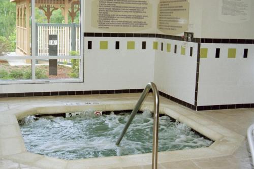 a bath tub with water in it in a room at Fairfield Inn & Suites Milledgeville in Milledgeville