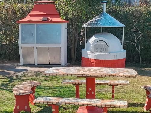 a group of picnic tables and a bird house at Casa - Chalet Valle del Reposo in Bialet Massé