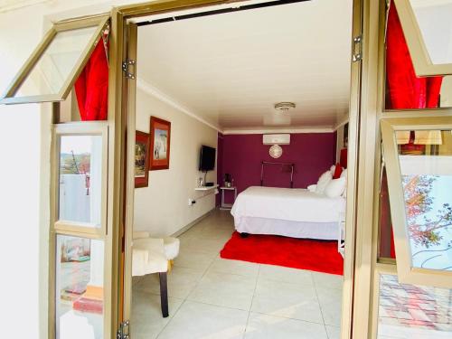 Ένα ή περισσότερα κρεβάτια σε δωμάτιο στο Pebetse Guesthouse