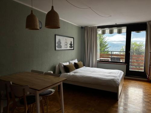 a bedroom with a bed and a table and a window at Apartment Vita in Bovec