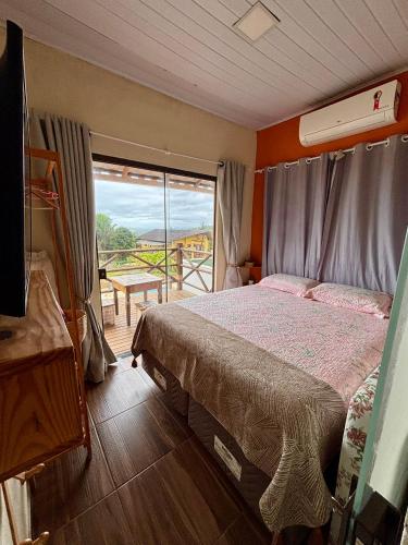 Ένα ή περισσότερα κρεβάτια σε δωμάτιο στο Mirante - Chalé Pura vida