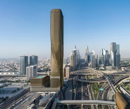 a view of a city with a tall skyscraper at Mandarin Oriental Downtown, Dubai in Dubai