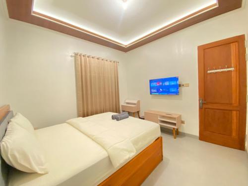 a hospital room with a bed and a tv at Fatmara Villa Full House in Kejajar