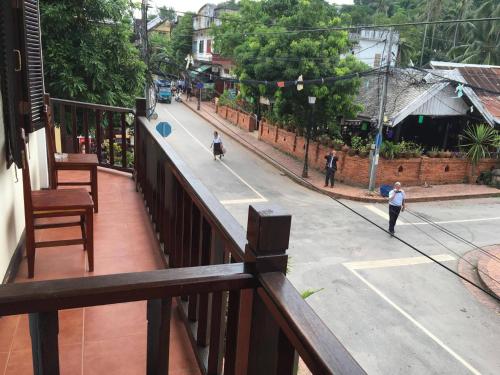 a view from a balcony of a street with people walking down the street at Villa Champa in Luang Prabang