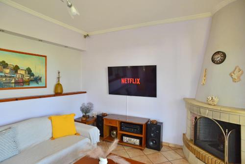 a living room with a tv and a fireplace at Tzitzi Pistachio Villa in Khlóï
