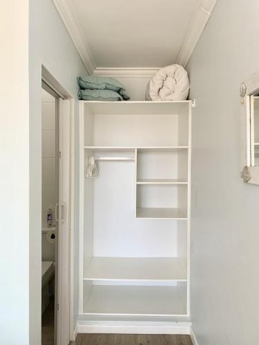 a walk in closet with white shelves at Southern Blue Agulhas in Agulhas