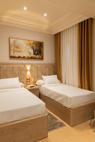 a hotel room with two beds in a room at Teba Hotel Ras Elbar in Ras El Bar