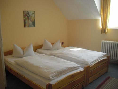 Tempat tidur dalam kamar di Hotel Feilen-Wolff
