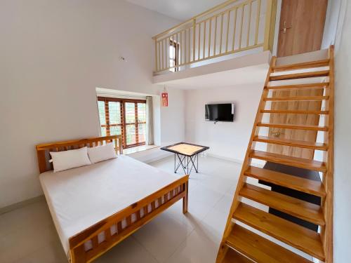 a bedroom with a bed and a staircase at Shlok Villa in Bāmangaon