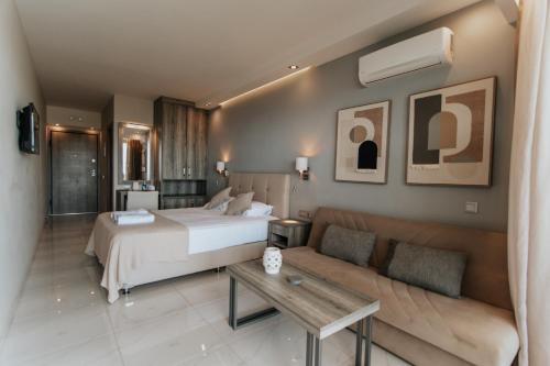 a hotel room with a bed and a couch at AKRON Luxury Holidays in Ancient Epidauros