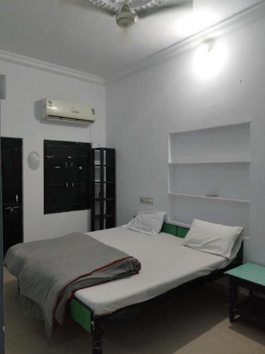 Un dormitorio con una cama grande con sábanas verdes y blancas. en Diamond Pushkar, en Jāmb