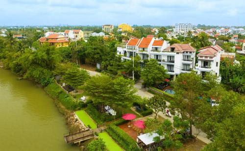 a group of buildings next to a river at Gia Huy Riverside Hotel Hoi An in Hoi An