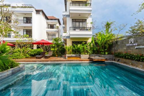 a swimming pool in front of a building at Gia Huy Riverside Hotel Hoi An in Hoi An