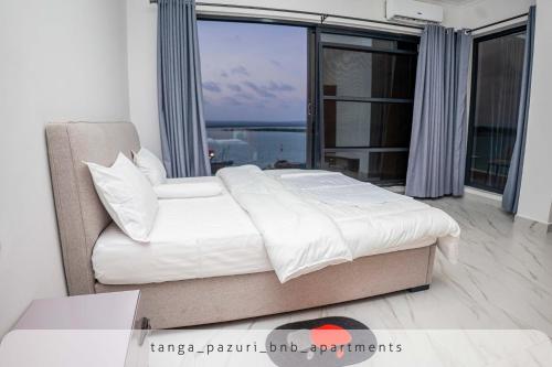 Postel nebo postele na pokoji v ubytování TANGA PAZURI APARTMENTS & BnB's
