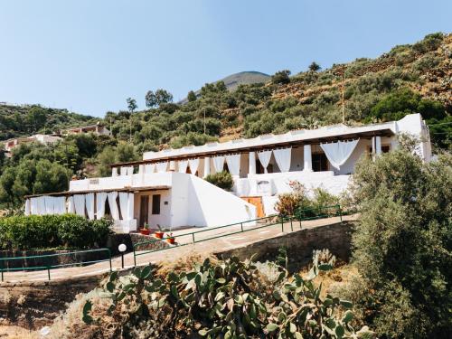 a white building on top of a hill at Salina Castel Vinci in Rinella