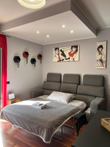 a bedroom with a bed and a couch at Lupin House in SantʼAngelo Romano