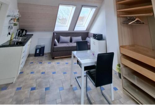 a small living room with a table and a couch at Dachgeschoss Harbour Apartments Höri in Moos