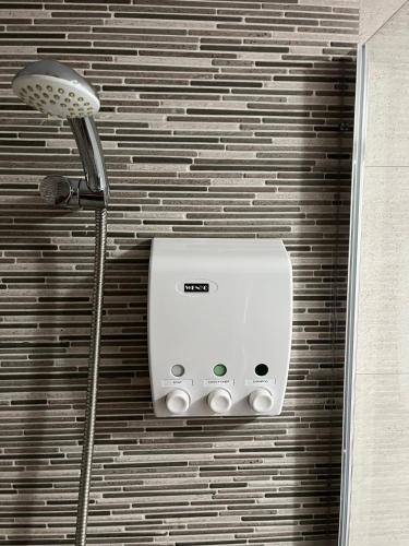 a shower head and a light on a wall at Nice and sunny apartment in Corralejo