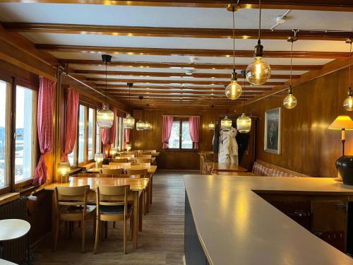 a restaurant with tables and chairs and a bar at Berggasthaus Auerhahn - Ski In- Ski Out- in Feldberg
