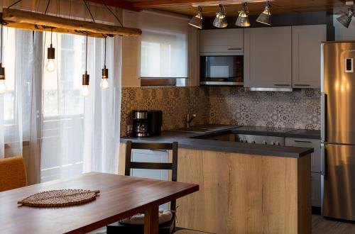 a kitchen with a table and a counter top at Apartment ILWA in Schladming