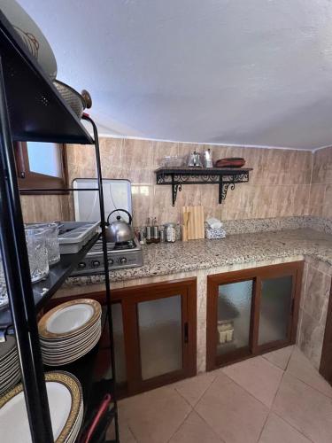 a kitchen with a stove and a counter top at Dar Al Hurra Appartement Andalou Chaouen in Chefchaouen