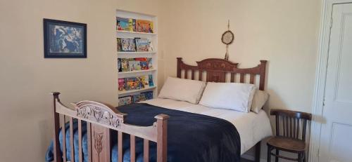 une chambre avec un lit et une étagère dans l'établissement Kalk Bay Apartment, à Kalk Bay