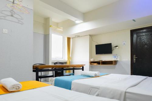 Una cama o camas en una habitación de Sans Hotel Havila Bengkulu