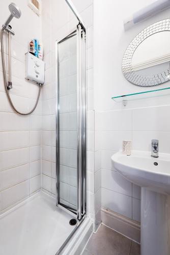 a bathroom with a shower and a sink at Garden flat near Ealing Broadway in London