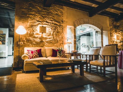 a living room with a couch and a table at Hotel El Convent 1613 in La Fresneda