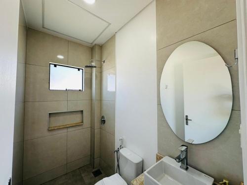 a bathroom with a sink and a mirror at Alojamiento Del Lago in Cambyretá