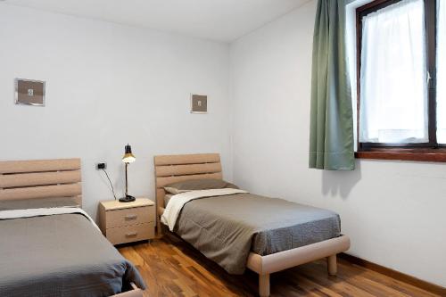 Ένα ή περισσότερα κρεβάτια σε δωμάτιο στο Jack Apartment In Pinzolo Center