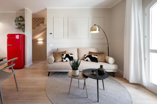 a living room with a white couch and a table at NEW Casa Florentia in Ambrogiana