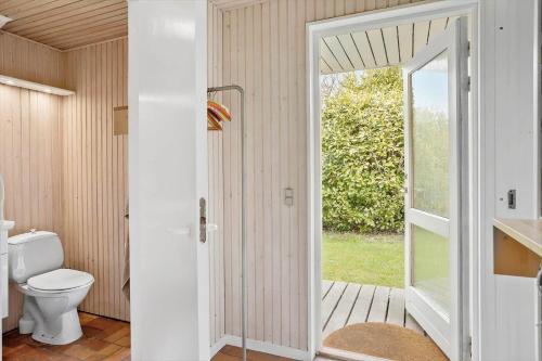 a bathroom with a toilet and an open door at 3004-Stege-Paelen-21 in Stege