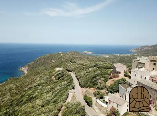 an aerial view of a house on a hill next to the ocean at Cap Helios l ecrin corse a couper le souffle in Morsiglia