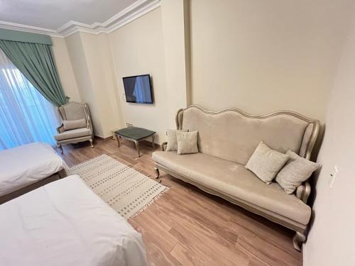 a living room with a couch and a chair at Sela 1 in Cairo