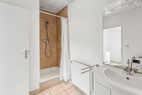 a white bathroom with a tub and a shower at For Workers Bedburg Hau in Bedburg Hau