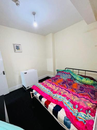 a bedroom with a bed with a colorful blanket at Sunnydale Homes in Rotherham