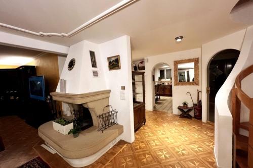 a living room with a staircase in a house at Chalet Maithili Lauterbrunnen -152-Year-Old Majestic Chalet in Lauterbrunnen